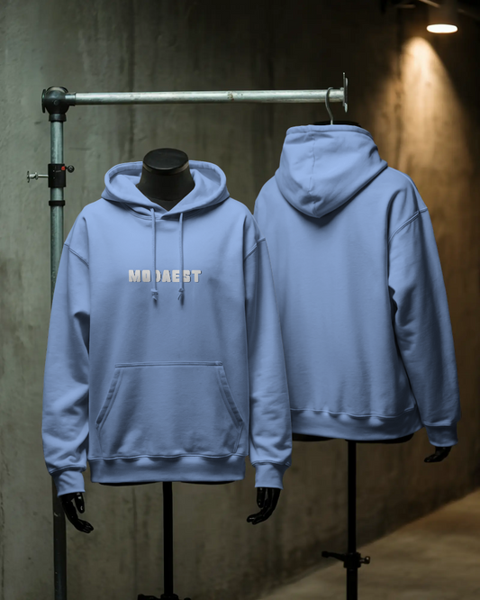 Light blue hoodie displayed on mannequins with 'MOJAEST' branding.