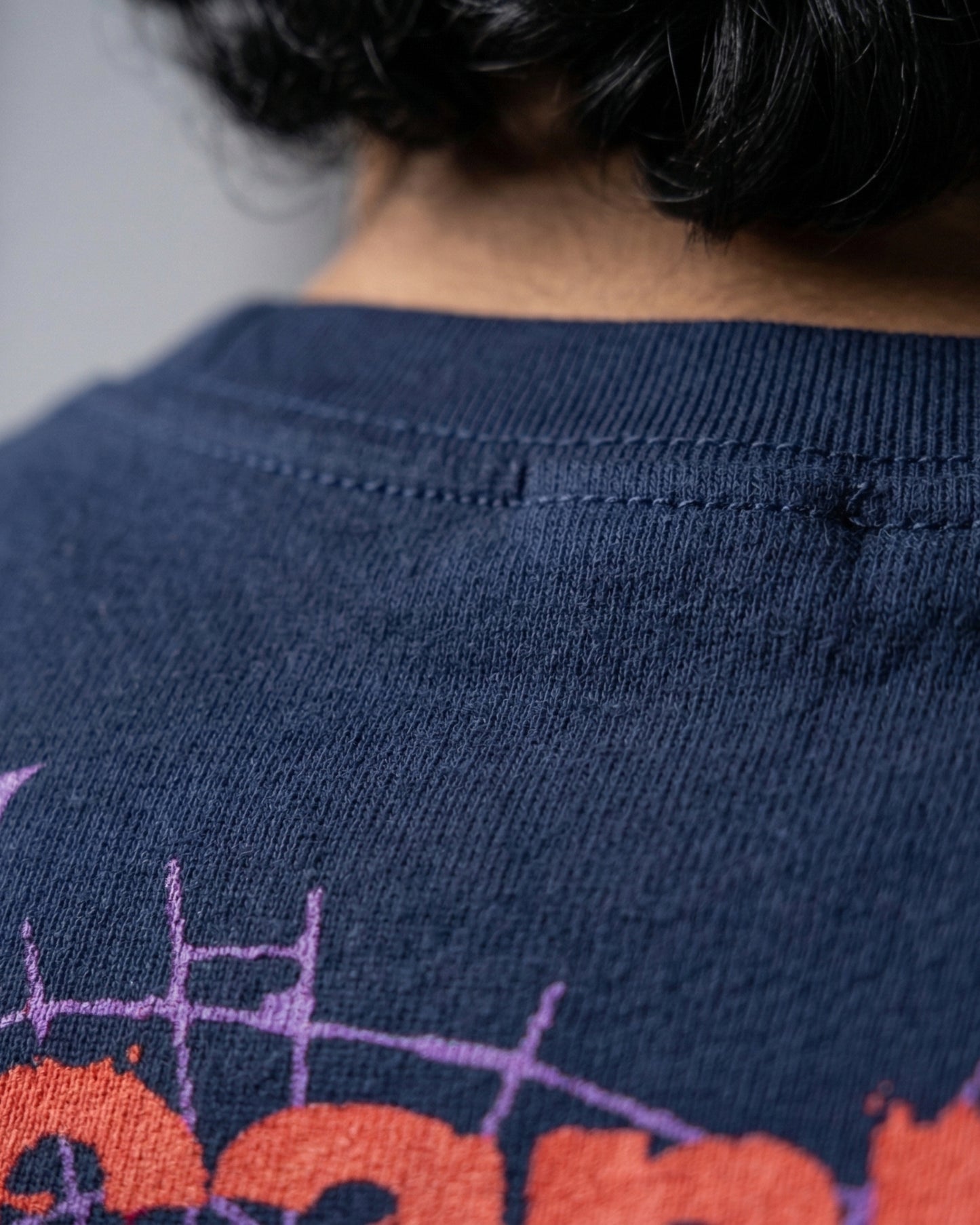 Modaest Arcanum oversized T-shirt with a graphic design, featuring a relaxed fit and casual style, displayed on a plain background.