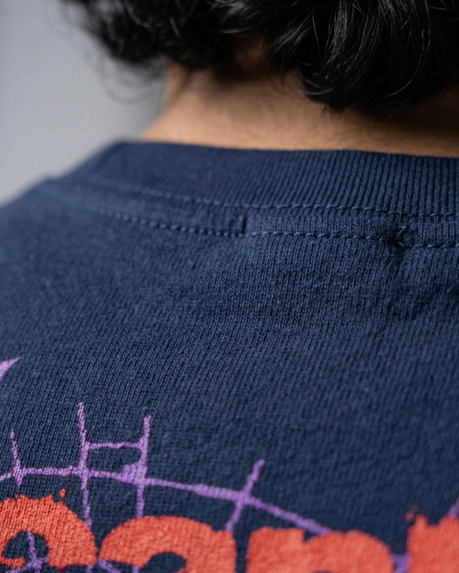 Modaest Arcanum oversized T-shirt with a graphic design, featuring a relaxed fit and casual style, displayed on a plain background.